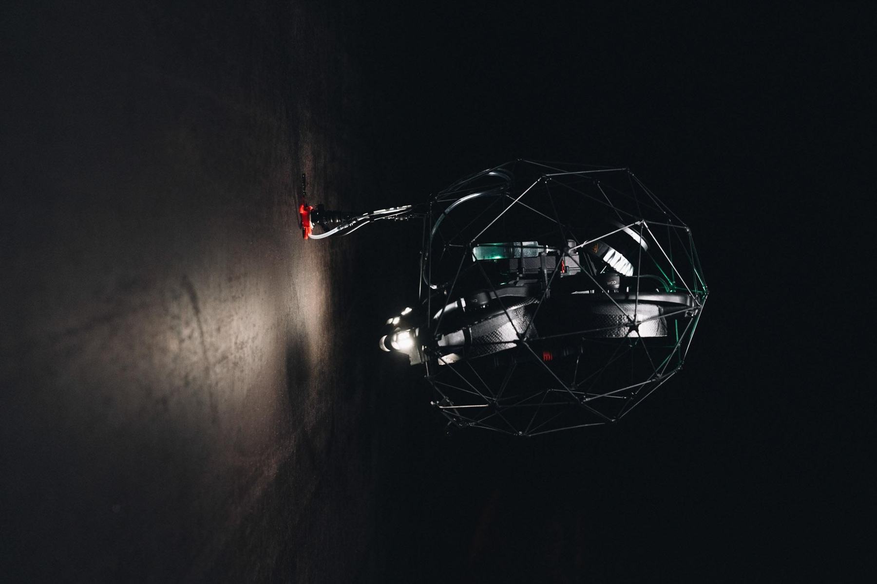 Elios 3 working against a vessel wall in darkness